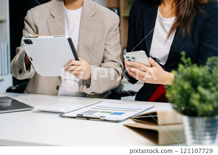 Businessman and team analyzing financial statement Finance task. with smart phone and laptop and tablet. Wealth management concept Businessman and team analyzing financial statement Finance task. with smart phone and laptop and tablet. Wealth management concept 121107729