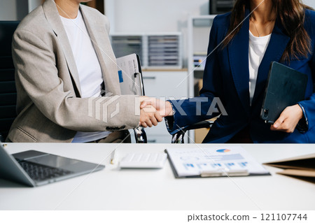 Two confident business man shaking hands during a meeting in the office, success, dealing, greeting and partner Two confident business man shaking hands during a meeting in the office, success, dealing, greeting and partner 121107744