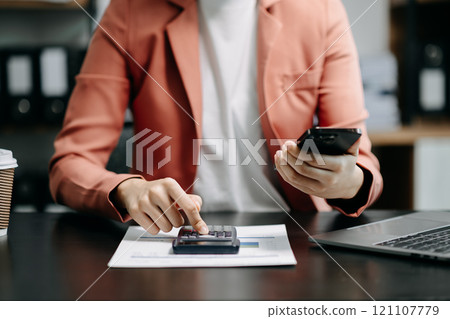 Close up of businesswoman or accountant hand typing laptop working to calculate on desk about cost Close up of businesswoman or accountant hand typing laptop working to calculate on desk about cost 121107779