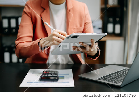 Close up of businesswoman or accountant hand typing laptop working to calculate on desk about cost 121107780
