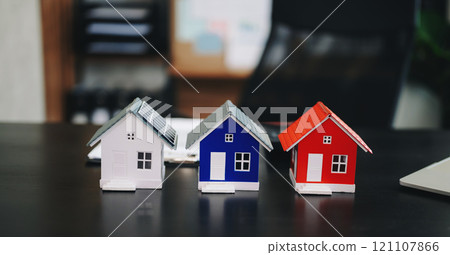 balancing the property sector The real estate agent is explaining the house style to see the house design and the purchase agreement. model house balancing the property sector The real estate agent is explaining the house style to see the house design and the purchase agreement. model house 121107866