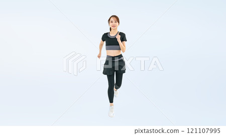 Full body photo of a woman running in sportswear 121107995