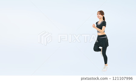 Full body photo of a woman running in sportswear 121107996