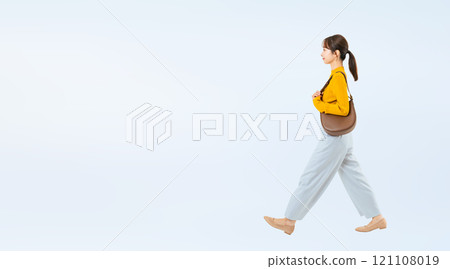 Full body photo of a walking woman in casual wear Full body photo of a walking woman in casual wear 121108019