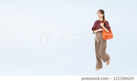 Full body photo of a walking woman in casual wear Full body photo of a walking woman in casual wear 121108024