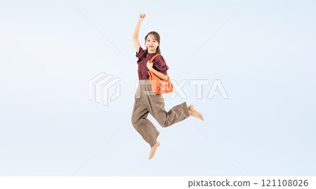 Full body photo of a woman in casual wear jumping Full body photo of a woman in casual wear jumping 121108026