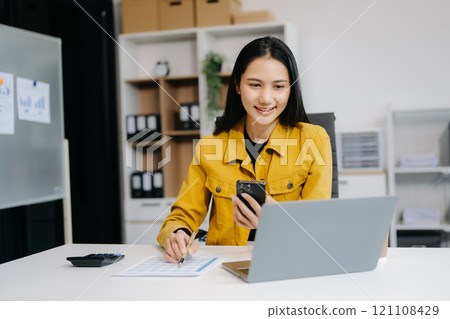 Asian Businesswoman Analyzing Finance on Tablet and Laptop at modern Office Desk tax Asian Businesswoman Analyzing Finance on Tablet and Laptop at modern Office Desk tax 121108429