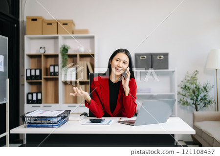 Asian Businesswoman Analyzing Finance on Tablet and Laptop at modern Office Desk tax Asian Businesswoman Analyzing Finance on Tablet and Laptop at modern Office Desk tax 121108437