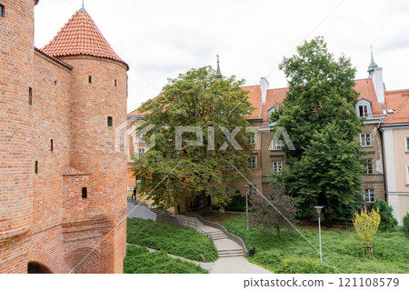 Barbacan castle and its fortification walls and structures. The streets of the old city. The sights of the Polish capital Warsaw. 121108579