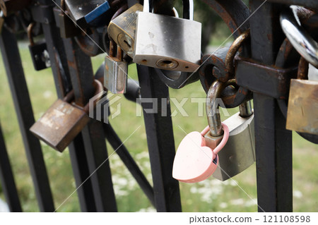 Pink lock in the shape of a heart. Locks for happiness, love and luck. Ritual and superstition. Pink lock in the shape of a heart. Locks for happiness, love and luck. Ritual and superstition. 121108598