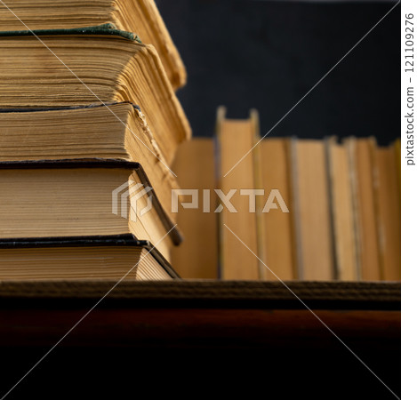 Collection of old books on wooden background. Book in the library. Bookshelf shop. Knowledge publications, literature. Bookish bookstore, bookshop. Booklover Collection of old books on wooden background. Book in the library. Bookshelf shop. Knowledge publications, literature. Bookish bookstore, bookshop. Booklover 121109276
