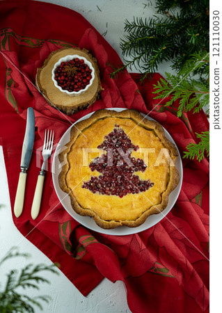 Cheesecake. Open round cake with lingonberries and cranberries with Christmas tree. Homemade sweet cake with berry filling. Festive food for dessert. New Year's and Christmas treats. Tart, casserole. 121110030