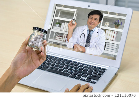 Back view of woman sit at desk at home have webcam conference on laptop computer with asian doctor about medical capsule. Healthcare and medicine concept. 121110076