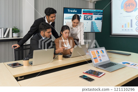 Group of business people in suit analyze stock information in the meeting room. Business executives team meeting in modern office with laptop computer, tablet, mobile phone on table. Group of business people in suit analyze stock information in the meeting room. Business executives team meeting in modern office with laptop computer, tablet, mobile phone on table. 121110296