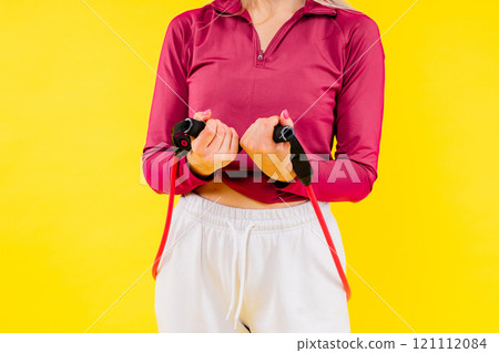 Sports woman in fashion sportswear exercising with elastic band in studio Sports woman in fashion sportswear exercising with elastic band in studio 121112084