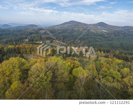 Panoramic view from viewpoint Stredni vrch near Dolni Prysk, Ceska Kamenice. Autumn landscape with colorful forest, hills and blue cloudy sky in Luzicke hory Lusatian Mountains, Czech Republic. Panoramic view from viewpoint Stredni vrch near Dolni Prysk, Ceska Kamenice. Autumn landscape with colorful forest, hills and blue cloudy sky in Luzicke hory Lusatian Mountains, Czech Republic. 121112291