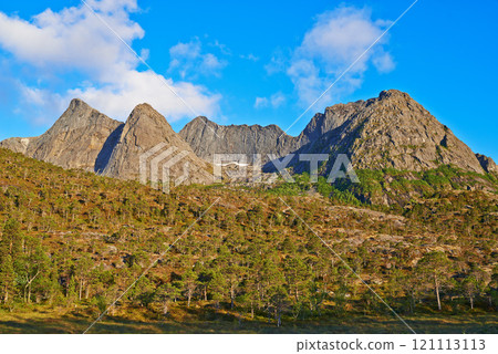 Landscape of mountains north of the polar and arctic circle in Norway. Scenic view of rolling hills in remote area with clouds in cold winter. Traveling abroad and overseas for holiday and vacation 121113113