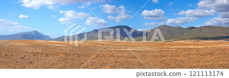 Landscape of harvested farm land on a cloudy day. Empty wheat field against a blue sky. Rural agriculture with dry pasture near mountains. Wide angle of empty dirt country for copy space background. Landscape of harvested farm land on a cloudy day. Empty wheat field against a blue sky. Rural agriculture with dry pasture near mountains. Wide angle of empty dirt country for copy space background. 121113174
