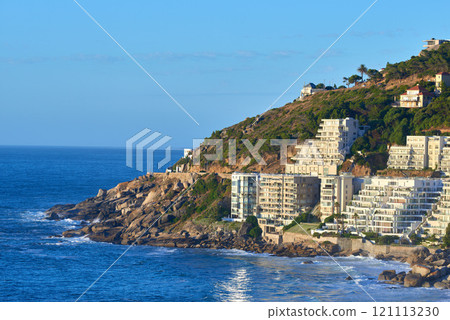 Clifton, Cape Town, South Africa panorama seascape with clear blue sky, hotels, and apartment buildings in the background. Housing development overlooking the beautiful blue ocean peninsula Clifton, Cape Town, South Africa panorama seascape with clear blue sky, hotels, and apartment buildings in the background. Housing development overlooking the beautiful blue ocean peninsula 121113230