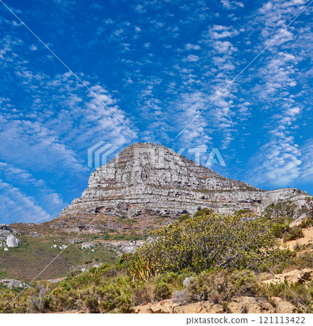 Copyspace with scenery of Lions Head at Table Mountain National Park in Cape Town, South Africa against a cloudy blue sky background. Panoramic of an iconic landmark and famous travel destination 121113422