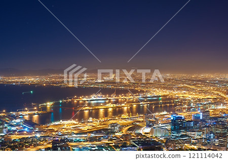 Aerial view of the night cityscape of Cape Town, South Africa. Wide angle of beautiful scenic view city lights in the evening. High angle view from the signal hill in the darkness in a coastal town. Aerial view of the night cityscape of Cape Town, South Africa. Wide angle of beautiful scenic view city lights in the evening. High angle view from the signal hill in the darkness in a coastal town. 121114042