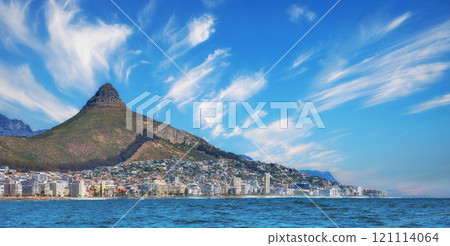 Copy space, panorama seascape with clouds, blue sky, hotels, and apartment buildings in Sea Point, Cape Town, South Africa. Lions head mountain overlooking the beautiful blue ocean peninsula 121114064