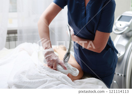 Hardware cosmetology. Anti-cellulite massage of the femoral zone in beauty salon. Body care. Non-surgical correction of figure. 121114113