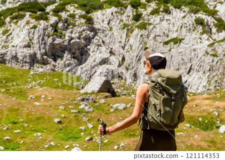 Young Woman Hiking Alone in Mountain Path Young Woman Hiking Alone in Mountain Path 121114353