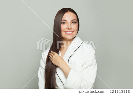 Cute model woman with sleek long shiny brown hair. Cosmetology, hair and skin care 121115118