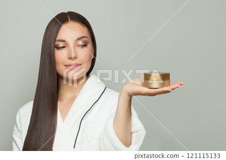 Beautiful woman holding a cream tube box in her palm hand on white background Beautiful woman holding a cream tube box in her palm hand on white background 121115133
