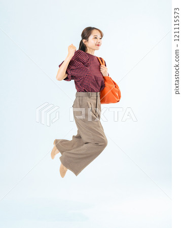 Full body photo of a woman in casual wear jumping 121115573