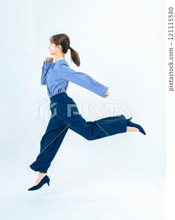Full-body photo of a female business person running in casual wear 121115580