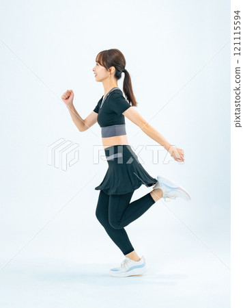 Full body photo of a woman running in sportswear 121115594