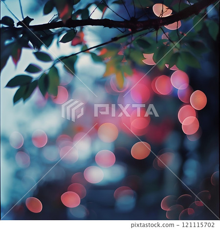 A somewhat blurry image depicting a tree branch adorned with leaves 121115702
