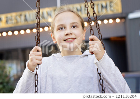 Positive child girl on playground. Kids play outdoor. Positive child girl on playground. Kids play outdoor. 121116204