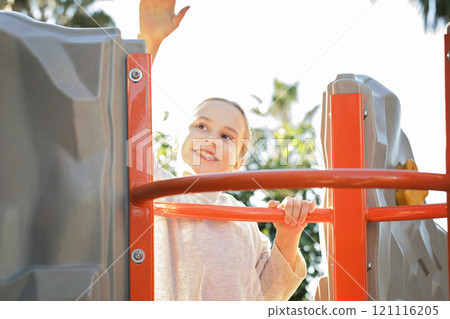 Joyful child girl on playground. Kids play outdoor. Joyful child girl on playground. Kids play outdoor. 121116205