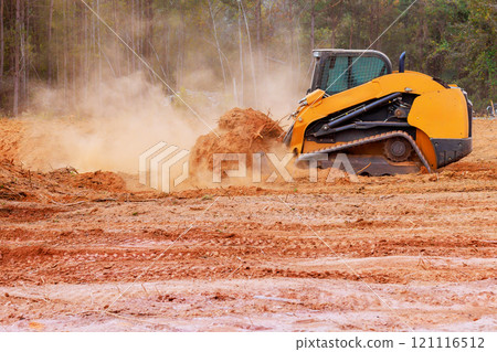 On construction site, bulldozer is leveling ground graded soil for preparing construction. On construction site, bulldozer is leveling ground graded soil for preparing construction. 121116512