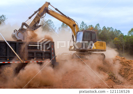 At construction sites, earth is loaded into dump truck with an excavator 121116526