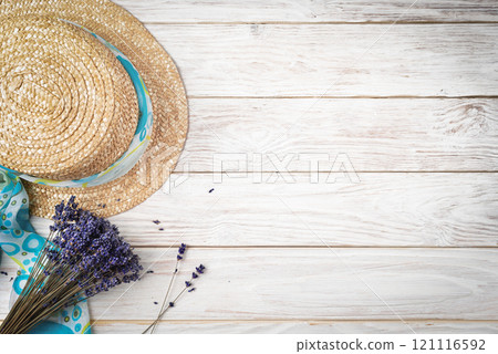Straw hat and lavender on white planks vacation planning background flat lay with copy-space Straw hat and lavender on white planks vacation planning background flat lay with copy-space 121116592