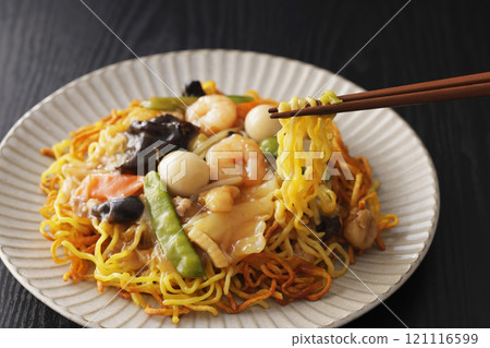 Fried noodles with thickened sauce, noodles picked up with chopsticks 121116599