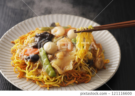 Fried noodles with thickened sauce, noodles picked up with chopsticks Fried noodles with thickened sauce, noodles picked up with chopsticks 121116600