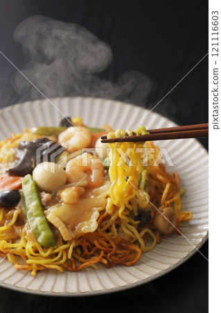 Fried noodles with thickened sauce, noodles picked up with chopsticks 121116603