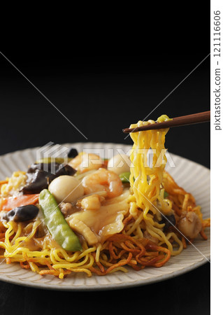 Fried noodles with thickened sauce, noodles picked up with chopsticks Fried noodles with thickened sauce, noodles picked up with chopsticks 121116606