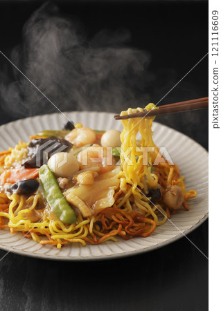 Fried noodles with thickened sauce, noodles picked up with chopsticks Fried noodles with thickened sauce, noodles picked up with chopsticks 121116609