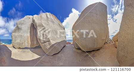 View through remarkable rock formations framing blue ocean under a bright sky during daytime 121116700