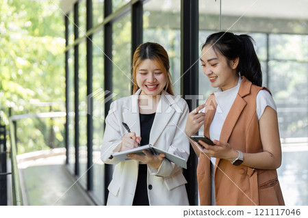 Business Professionals Collaborating in Modern Office Environment with Digital Devices and Documents 121117046