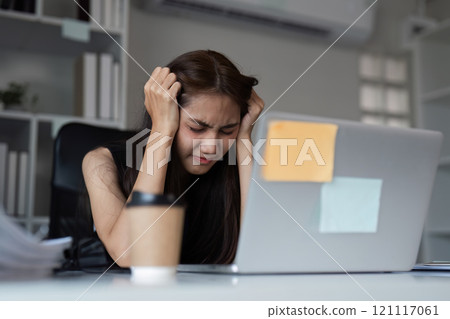 Stressed Office Worker Struggling with Workload in Modern Corporate Environment Stressed Office Worker Struggling with Workload in Modern Corporate Environment 121117061