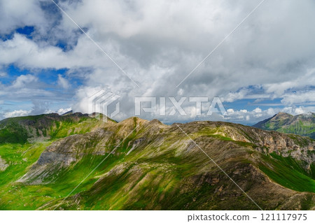 Picturesque Mountain Landscape with Lush Green Hills and Cloudy Sky Kaprun, Austria 121117975