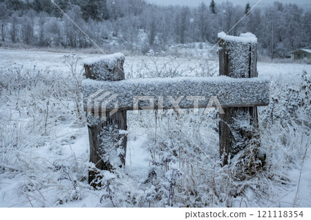 Little wooden fence during snowfall, Liland, Norway 121118354
