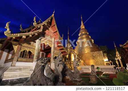 Chapel and golden pagoda at Wat Phra Singh Woramahawihan illuminated at dusk, Chiang Mai, Thailand Chapel and golden pagoda at Wat Phra Singh Woramahawihan illuminated at dusk, Chiang Mai, Thailand 121118517
